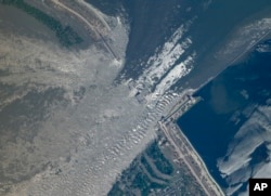 This satellite image provided by Planet Labs PBC shows an overview of the damage at the Kakhovka dam in southern Ukraine, June 6, 2023.