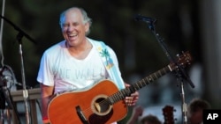FILE - Jimmy Buffett performs at his sister's restaurant in Gulf Shores, Ala., on June 30, 2010.