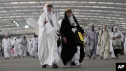 FILE - Iranian pilgrims walk to cast stones at a pillar in the symbolic stoning of the devil, the last rite of the annual Hajj pilgrimage, in Mina near the holy city of Mecca, Saudi Arabia, June 29, 2023.