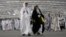 FILE - Iranian pilgrims walk to cast stones at a pillar in the symbolic stoning of the devil, the last rite of the annual Hajj pilgrimage, in Mina near the holy city of Mecca, Saudi Arabia, June 29, 2023.