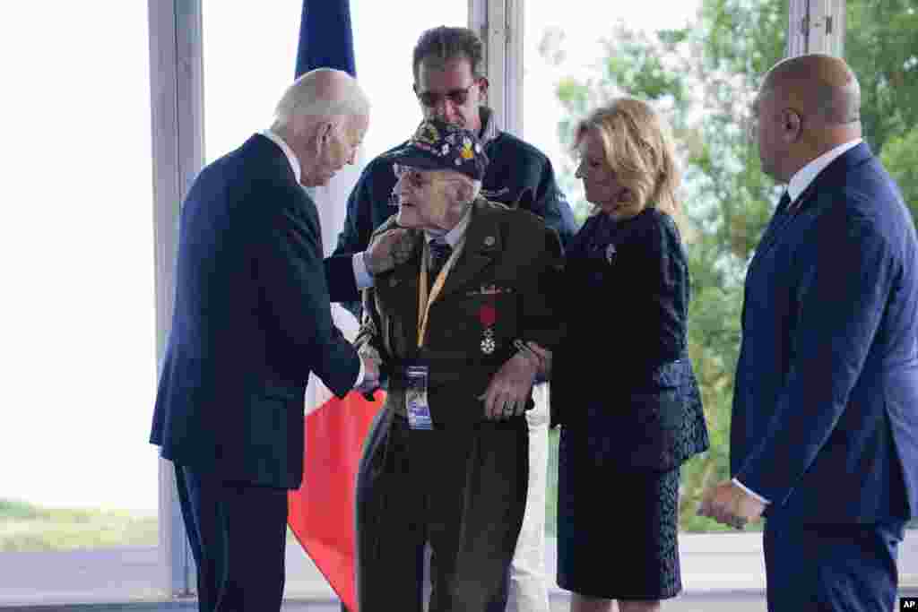 President Joe Biden and first lady Jill Biden greet a World War II veteran during ceremonies to mark the 80th anniversary of D-Day, June 6, 2024, in Normandy, France.