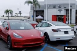 FILE - Tesla Model 3 vehicles are shown for sale at a Tesla facility in Long Beach, California, May 22, 2023.