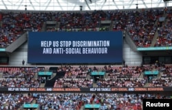 An anti-discrimination message is shown on a big screen at London's Wembley Stadium during a soccer match between Manchester United and Manchester City on Aug. 10, 2024.