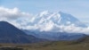 FILE - Sightseeing buses and tourists are seen at a pullout popular for taking in views of North America's tallest peak, Denali, in Denali National Park and Preserve, Alaska, Aug. 26, 2016.