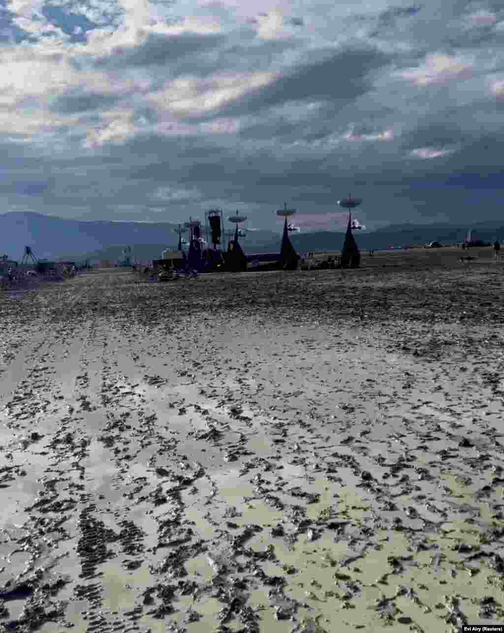 View of the muddy terrain during the Burning Man event at the temporary desert settlement of Black Rock City, Nevada, Sept. 2, 2023 in this still image from social media video.