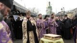 Priests of Ukrainian Orthodox Church pray with their supporters after resisting a government order to leave the Kyiv Pechersk Lavra monastery complex in Kyiv, Ukraine, April 1, 2023