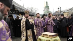 Priests of Ukrainian Orthodox Church pray with their supporters after resisting a government order to leave the Kyiv Pechersk Lavra monastery complex in Kyiv, Ukraine, April 1, 2023