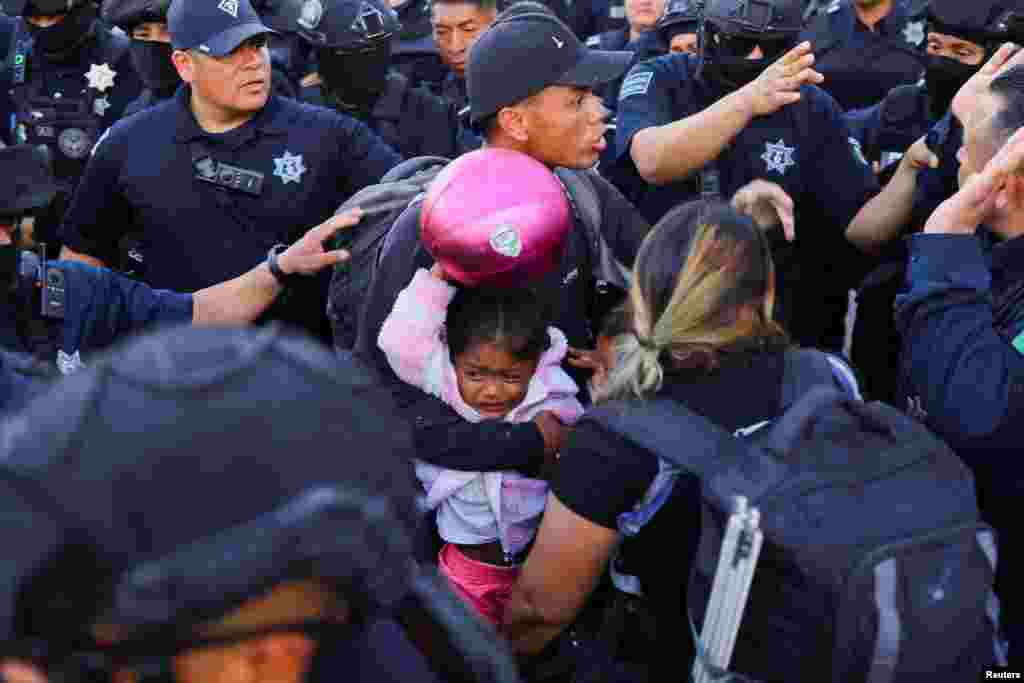 Police evict migrants, mostly from Venezuela, from a camp that was located in front of the migration detention center where migrants died during a fire in March, in Ciudad Juarez, Mexico, May 22, 2023.