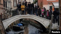 Boats are pictured in a canal during a severe low tide in the lagoon city of Venice, Italy, Feb. 17, 2023. 