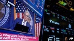 FILE - A news conference with Federal Reserve Chair Jerome Powell is seen on a monitor on the floor at the New York Stock Exchange in New York, May 1, 2024.