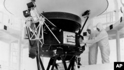 FILE - In this Aug. 4, 1977, photo provided by NASA, the 'Sounds of Earth' record is mounted on the Voyager 2 spacecraft in the Safe-1 Building at the Kennedy Space Center, Fla.