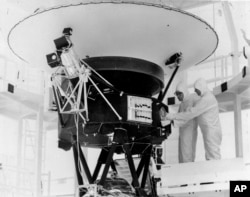 In this Aug. 4, 1977, photo provided by NASA, the 'Sounds of Earth' record is mounted on the Voyager 2 spacecraft in the Safe-1 Building at the Kennedy Space Center, Fla. (AP Photo/NASA, File)