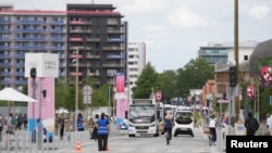 People travel near the Team USA residence building at the 2024 Paris Olympics athlete village in Saint-Denis, France, July 23, 2024. (Kirby Lee/USA Today Sports)