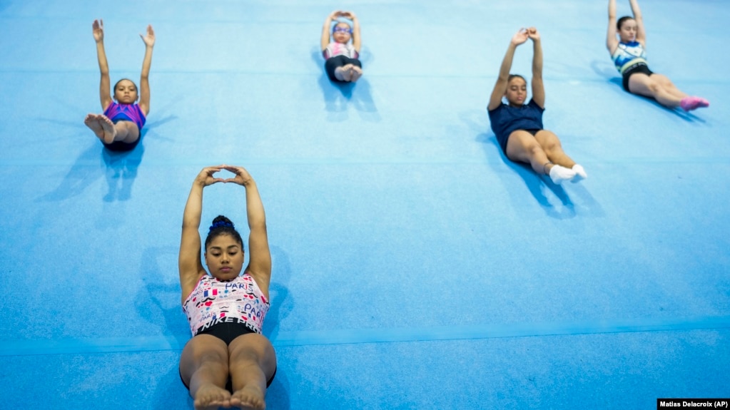 FILE - Panamanian gymnast Hillary Heron stretches as she trains for the Olympics at the No Limits Gymnastics Center in Panama City, Saturday, June 15, 2024, ahead of the Games in Paris. (AP Photo/Matias Delacroix, File)