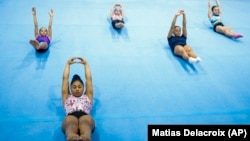 FILE - Panamanian gymnast Hillary Heron stretches as she trains for the Olympics at the No Limits Gymnastics Center in Panama City, Saturday, June 15, 2024, ahead of the Games in Paris. (AP Photo/Matias Delacroix, File)