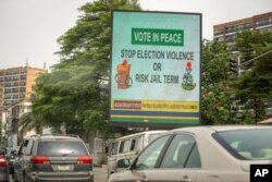 FILE - An electronic billboard carries a message warning the public against engaging in election violence, in Lagos, Nigeria, Feb. 23, 2023.
