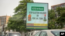 An electronic billboard carries a message warning the public against engaging in election violence, in Lagos, Nigeria, Feb. 23, 2023. On Feb. 25, voters will choose among 18 candidates in a first-round vote to succeed incumbent President Muhammadu Buhari.
