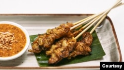 GOOD Meat cultivated chicken satay made in Singapore is plated as part of a demonstration on May 17, 2022. (Photo: Eat Just, Inc.)