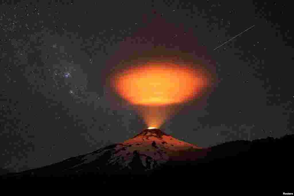 The Villarrica volcano lights up the sky at night seen from Pucon town, Chile, Dec. 14, 2023.