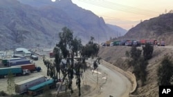 FILE - Trucks sit at the Torkham border crossing point on Afghanistan's border with Pakistan, Feb. 21, 2023. Pakistani authorities closed the crossing on Sept. 6, 2023, after border guards from the two sides exchanged fire, officials and residents said.