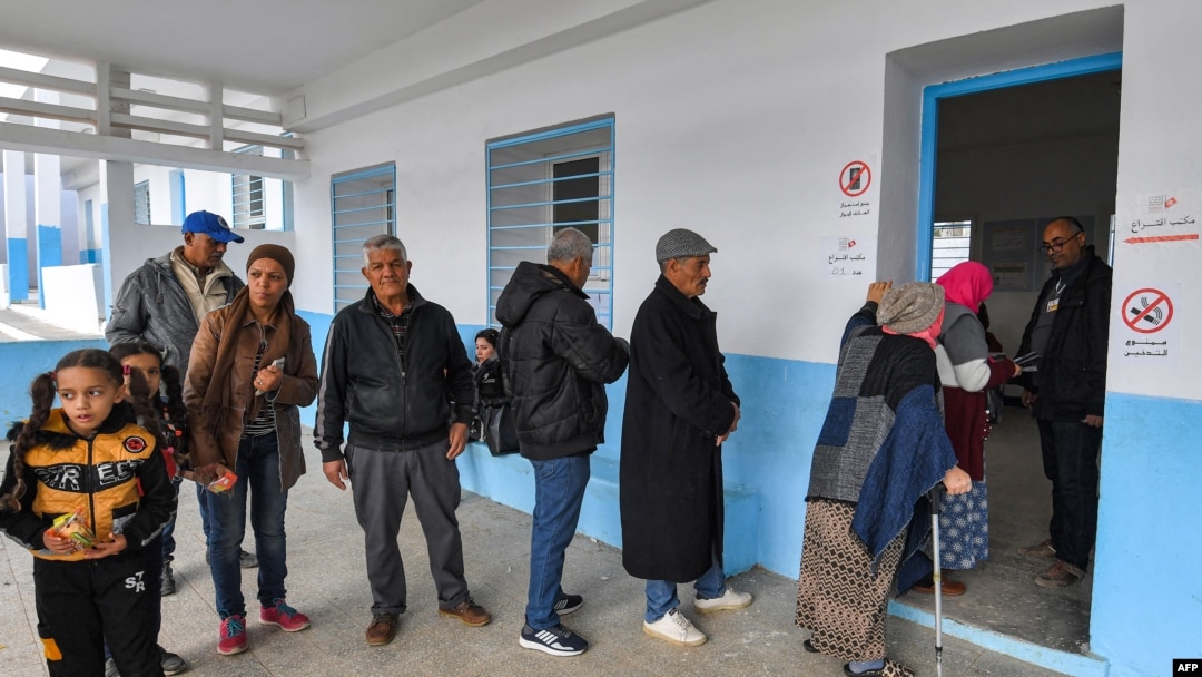 Voters queue outside a polling station during the 2023 local elections in the locality of Mnihla in Ariana province on the outskirts of Tunis on Dec. 24, 2023.