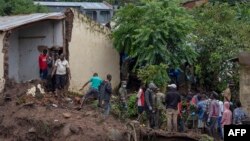 Malawi defense force soldiers work with community members to recover bodies of victims of landslides after heavy rains from Cyclone Freddy in Blantyre, Malawi, March 16, 2023. 