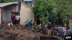 Malawi Defence Force soldiers work with community members to recover bodies of victims of landslides after heavy rains from Cyclone Freddy in Blantyre, Malawi, March 16, 2023. 