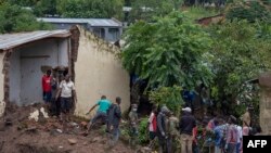 FILE: Malawi Defence Force soldiers work with community members to recover bodies of victims of landslides after heavy rains from Cyclone Freddy in Blantyre, Malawi, March 16, 2023. 