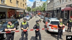 Police cordon off an area near the Reeperbahn in Hamburg, Germany, June 16, 2024. Police say officers have shot and wounded a man who was threatening them with an axe and a firebomb.
