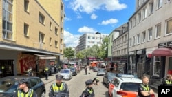 Police cordon off an area near the Reeperbahn in Hamburg, Germany, June 16, 2024. Police say officers have shot and wounded a man who was threatening them with an axe and a firebomb.