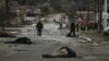 The bodies of civilians lie on Yablunska Street in Bucha, northwest of Kyiv. The first body in the picture has been identified as Mykhailo Kovalenko, who was shot dead by Russian soldiers, according to relatives interviewed by AFP. April 2, 2022. (Photo by RONALDO SCHEMIDT / AFP)