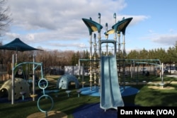 Children of all sizes can use the playground's slides. (Dan Novak/VOA)