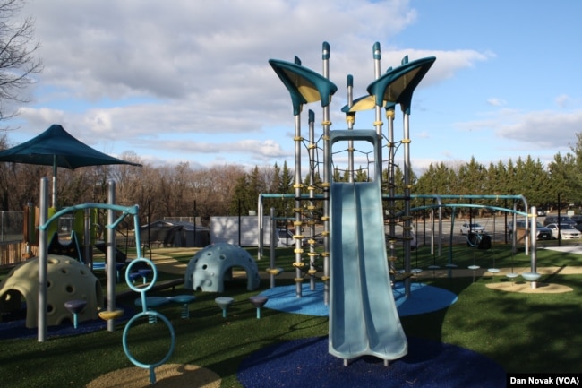 Children of all sizes can use the playground's slides. (Dan Novak/VOA)