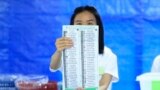 A Thai officer shows a ballot during vote counting at polling station in Bangkok, Thailand, May 14, 2023. 