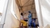 FILE - A health worker attends to an mpox patient at a treatment center in Munigi, eastern Congo, Aug. 19, 2024.