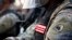 FILE - A solider from the District of Columbia National Guard watches as demonstrators gather to protest the death of George Floyd, June 3, 2020, near the White House in Washington. 