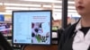 FILE - A woman pays for groceries at a supermarket in Bellflower, Calif., Feb. 13, 2023. 