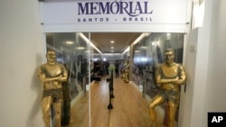FILE - Statues of Pele stand at the entrance of the Brazilian soccer great's mausoleum at Necropole Ecumenica Memorial Cemetery in Santos, Brazil on Monday, May 15, 2023.