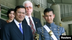 FILE - Cambodia's Prime Minister Hun Sen, left, stands with his son Hun Manet after graduation ceremonies at the United States Military Academy at West Point, May 29, 1998.