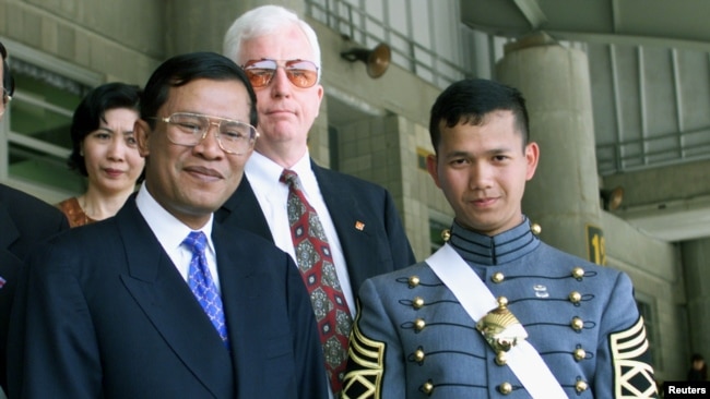 Cambodia's Prime Minister Hun Sen, left, stands with his son Hun Manet after graduation ceremonies at the United States Military Academy at West Point, May 29, 1998.