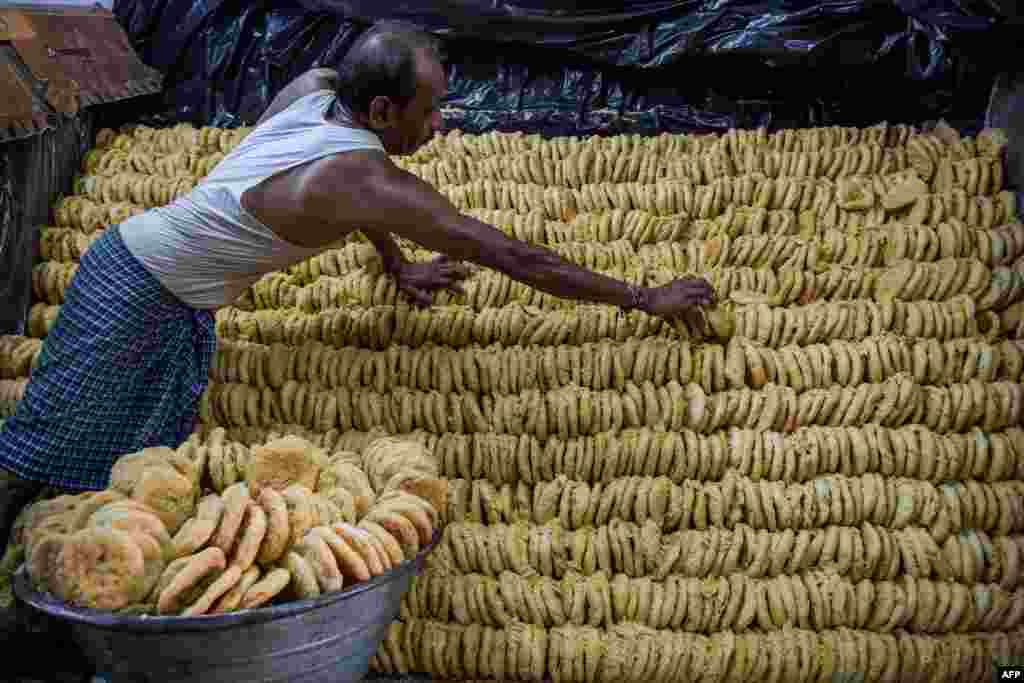 A worker arranges a traditional sweetmeat locally known as &quot;Khaja&quot; which are popularly sold ahead of Hindu festival of &quot;Nag Panchami&quot;, at a workshop in Ahmedabad, India.