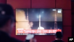 A TV screen shows a file image of North Korea's rocket launch during a news program at a bus terminal in Seoul, South Korea, May 27, 2024. 