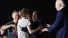 Russian-American journalist Alsu Kurmasheva, who was released from detention in Russia, speaks to her daughters Bibi and Miriam Butorin, and husband Pavel Butorin, as President Joe Biden looks on, at Joint Base Andrews in Maryland, Aug. 1, 2024. 