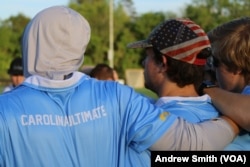 Members of the University of North Carolina's Darkside ultimate frisbee team group together at a practice session in Chapel Hill, North Carolina, Thursday April 13, 2023. (VOA/Andrew Smith)