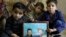 Children of Mohammed Hassan, a Pakistani porter who died on July 27 during a summit of K2, hold a portrait of their father and grandfather in northern Pakistan, Aug. 12, 2023.