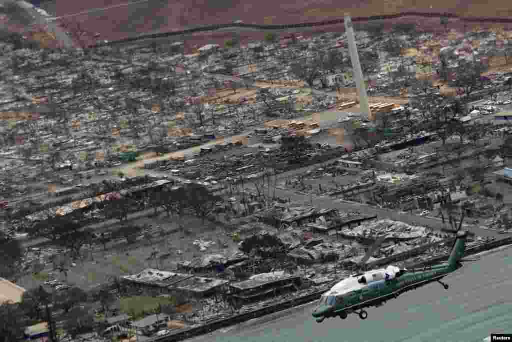 U.S. President Joe Biden, aboard Marine One, inspects the burned town of Lahaina on the island of Maui in Hawaii, Aug. 21, 2023.