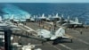 In this photograph released by the U.S. Navy, the flight deck of the Nimitz-class aircraft carrier USS Theodore Roosevelt is seen July 4, 2024, in the South China Sea. 