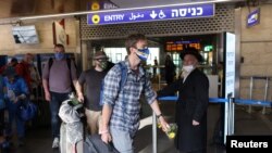 FILE - Tourists walk at the Ben Gurion International Airport near Tel Aviv, Israel, May 27, 2021. The U.S. will admit Israel into its Visa Waiver Program, and citizens of both countries will be allowed entry to the other without a visa for up to 90 days.