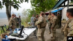 FILE - U.S. Marines and Philippine troops work together during a joint military exercise called "Balikatan," Tagalog for shoulder-to-shoulder, at Capas, Tarlac province, northern Philippines, April 14, 2023.