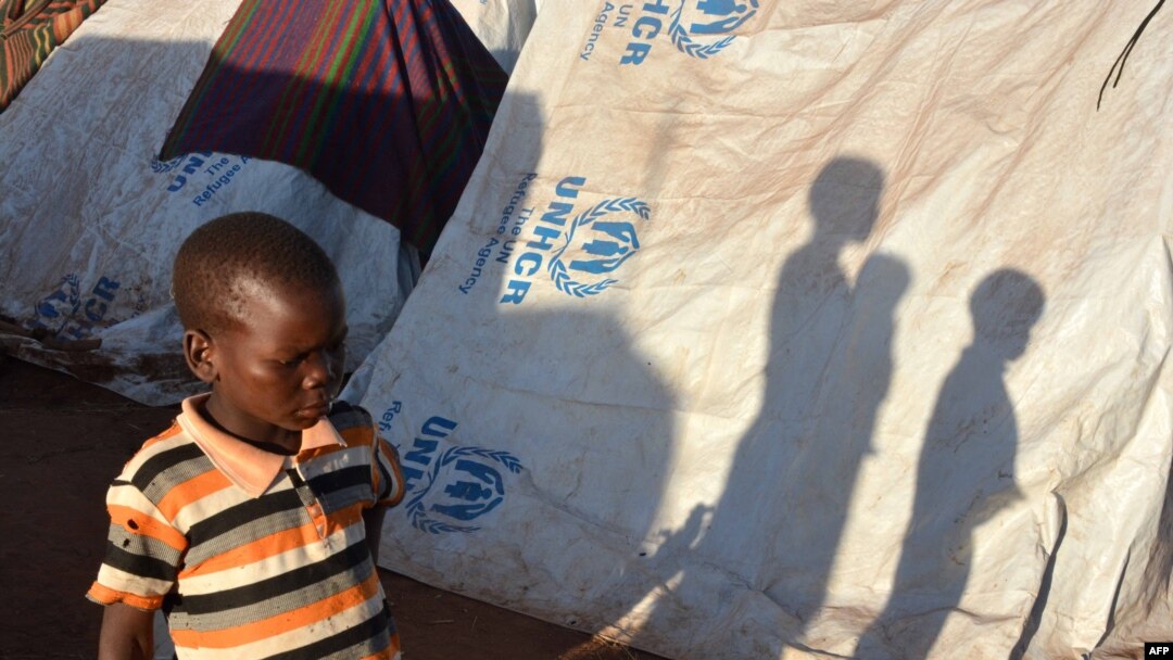 FILE - Refugees wait for registration at the Kapisi refugee camp in Malawi's Mwanza district on the Malawi-Mozambique border, Jan. 7, 2015.